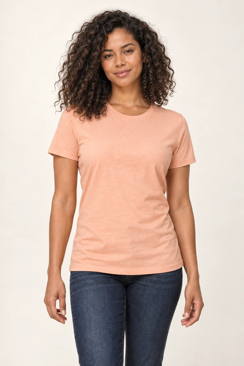 A model wearing a peach BELLA+CANVAS 3001 tee, front view